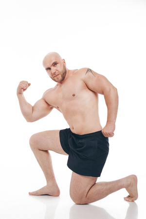 Strong naked muscular man shows off his musclesの写真素材