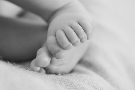 the feet of a newborn baby close-upの写真素材