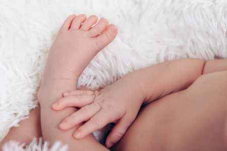 hand and leg of newborn baby close up onの写真素材