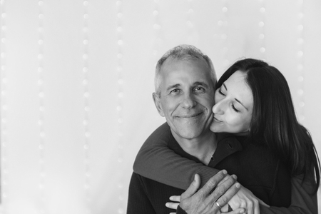 couple in love hugs on white background. man and woman smiling. Valentine's dayの写真素材