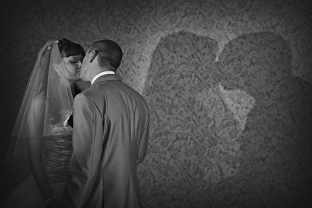 play of light and shadow: bride and groom face to face. A man kisses a woman. Valentines dayの写真素材
