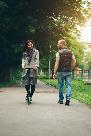 Valentine's day: a couple in love riding a scooter on the streetの写真素材