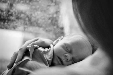 baby in the arms of the mother. Woman holding a childの写真素材