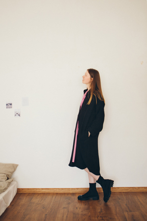 beautiful girl in long linen coat on white background. Model in advertising clothingの写真素材