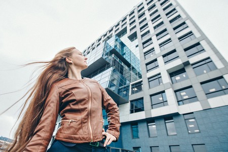 portrait of a beautiful girl on the background of the urban landscapeの写真素材