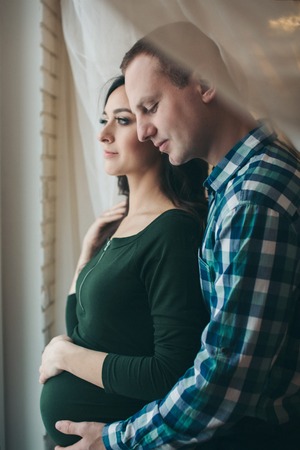 couple in love hugs. man and pregnant woman smiling. Valentine's dayの写真素材
