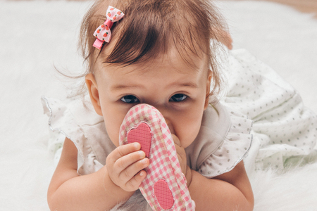 Newborn baby and a pair of baby shoesの写真素材