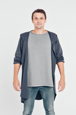 handsome man shows off gray clothes on white backgroundの写真素材