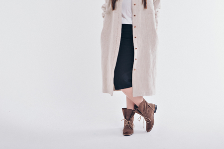 beautiful girl in long linen coat on white background. Model in advertising clothingの写真素材