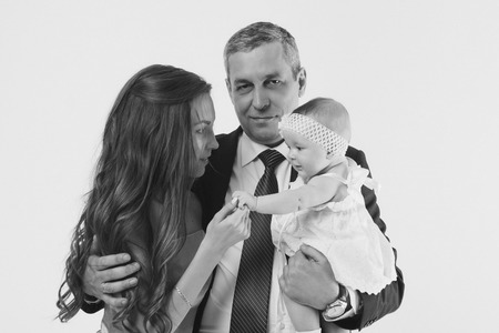 baby on the hands of parents on a white background.の写真素材