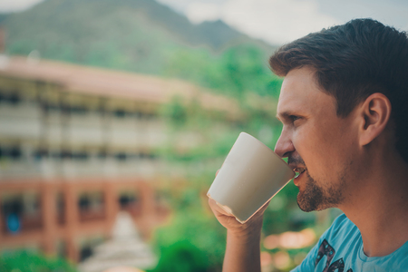 portrait of man holding a large mugの写真素材