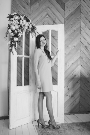 Beautiful girl without makeup in pink dress with on home interior backgroundの写真素材