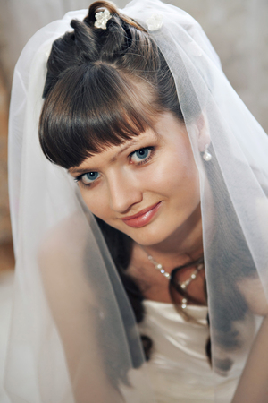 portrait of the bride in a veil. The girl is preparing for the weddingの写真素材