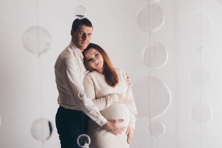 couple in love hugs. man and pregnant woman smiling. Valentine's dayの写真素材