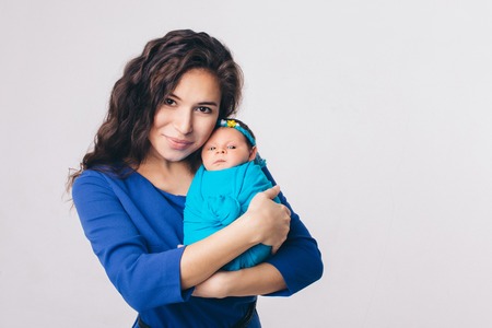 baby in the arms of the mother. Woman holding a childの写真素材