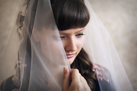 portrait of the bride in a veil. The girl is preparing for the weddingの写真素材