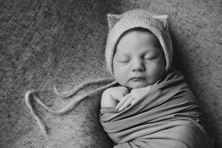 newborn baby in a hat with earsの写真素材