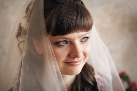 portrait of the bride in a veil. The girl is preparing for the weddingの写真素材