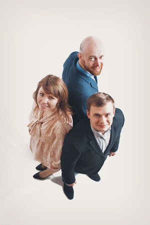 top view: three people back to back. Men and women in business suitsの写真素材