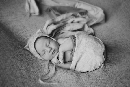 newborn baby in a hat with earsの写真素材