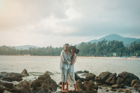 man and woman standing in the water and huggingの写真素材