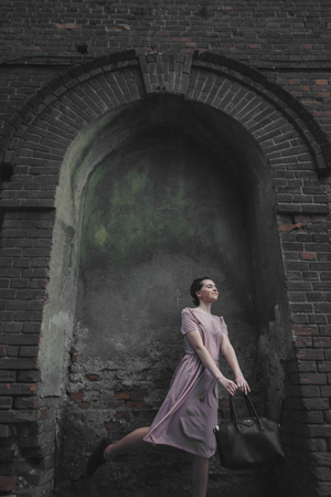 portrait of a beautiful girl on the background of the urban landscapeの写真素材