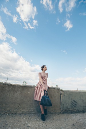 portrait of a beautiful girl on the background of the urban landscapeの写真素材