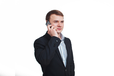 Smiling business man talking on the cell phone, isolated on white backgroundの写真素材