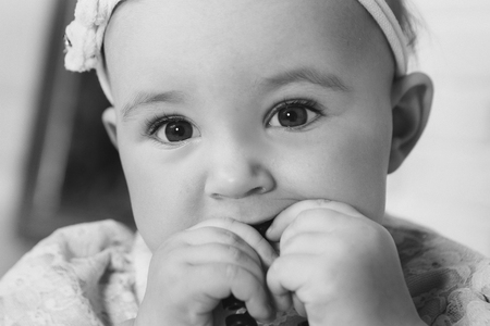 portrait of a newborn baby with a pen at the faceの写真素材