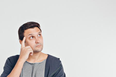 portrait of man thoughtful. Guy with hands on face isolated on white backgroundの写真素材