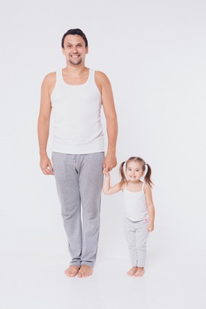 Cute baby learning to walk and make his first steps. mom is holding his hand. child's feet close up, copy spaceの写真素材