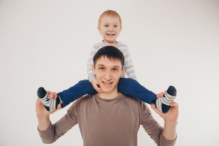 Dad holds the baby in his arms. The concept of educating the father of young children, Happy childhood, a friendly family.の写真素材