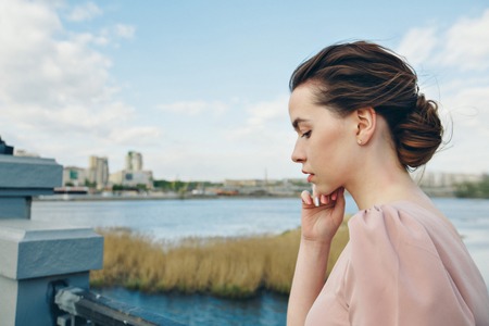 portrait of a beautiful girl on the background of the urban landscapeの写真素材