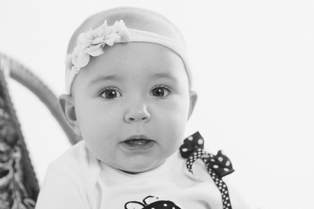 the face of a child with a bandage with flowers on his head close-upの写真素材