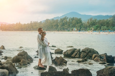 man and woman standing in the water and huggingの写真素材