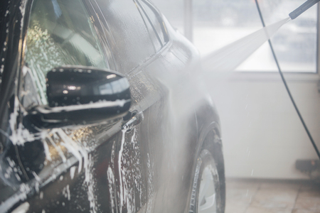 car wash. Detail of the machine in the foam close-up. the surface of the machineの写真素材