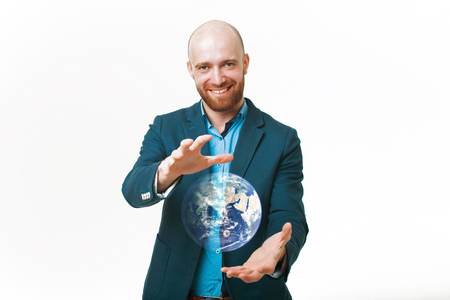 cute bald smiling man on a white background holding a planet in front of himの写真素材