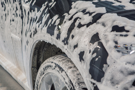car wash. Detail of the machine in the foam close-up. the surface of the machineの写真素材