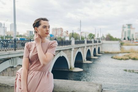 portrait of a beautiful girl on the background of the urban landscapeの写真素材
