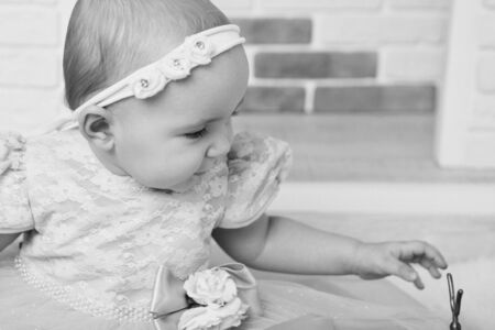 the face of a child with a bandage with flowers on his head close-upの写真素材
