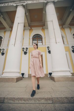 portrait of a beautiful girl near the columns of the theater or Museumの写真素材