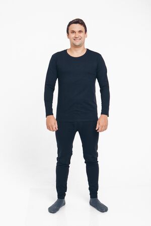 the concept of advertising pajamas, underwear - handsome man shows off gray clothes on a white backgroundの写真素材