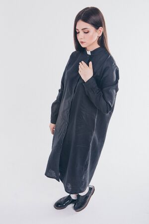 nun on white background. A girl in a black shirt with a white collar. the concept of Church educationの写真素材