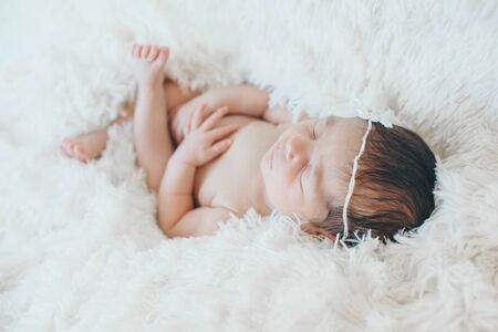 the concept of healthy lifestyle, IVF - a newborn baby sleeps under a blanket. Head, legs and armsの写真素材