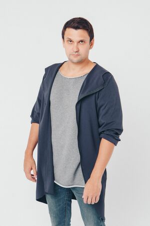 handsome man shows off gray clothes on white backgroundの写真素材