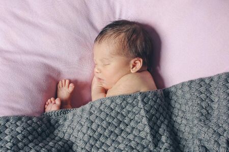newborn baby sleeps wrapped in a blanket. concept of childhood, healthcare, IVFの写真素材