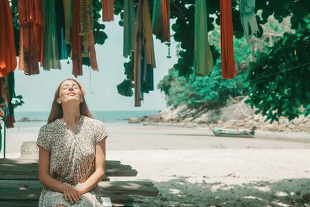 the concept of rest, travel - a beautiful girl sunbathing. Tourist on the island. decoration in the shape of a crossの写真素材