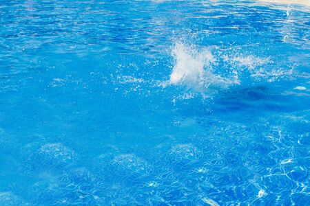 splashes of blue water in the pool close-up. copy spaceの写真素材