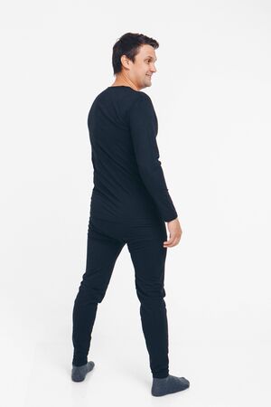 the concept of advertising pajamas, underwear - handsome man shows off gray clothes on a white backgroundの写真素材