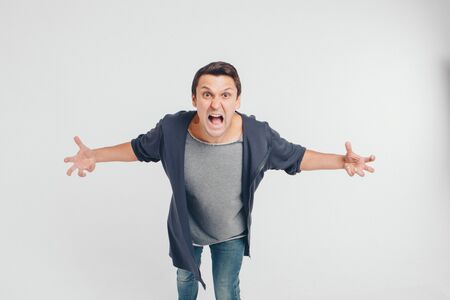 portrait of a man who screams. Isolated on white background. concept of freedom of expression of feelings, emotions, hysterics, anger, indignationの写真素材